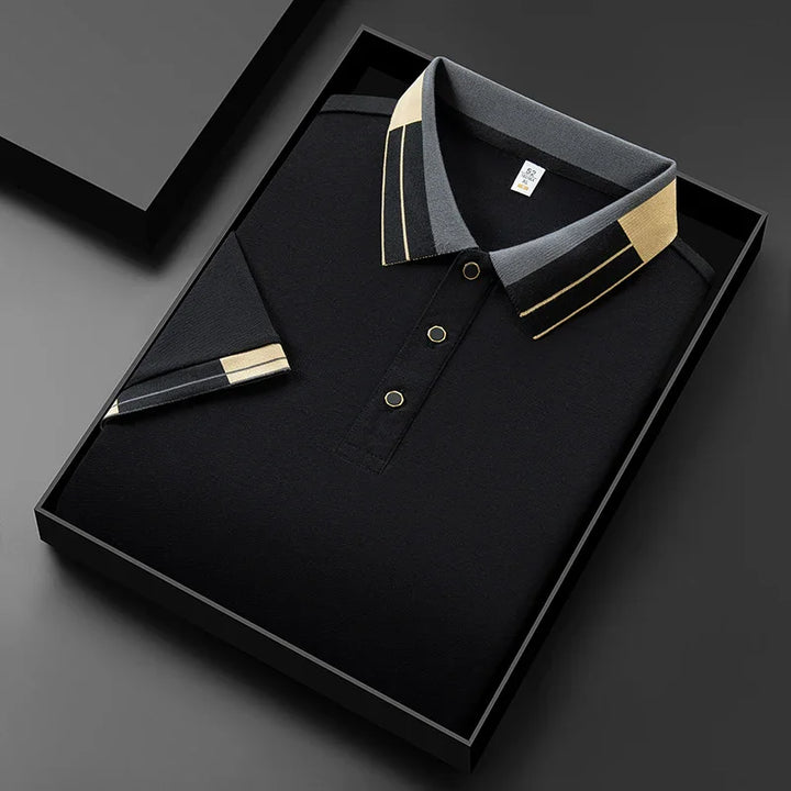 Black polo shirt with gray and beige geometric collar and sleeve cuff, neatly folded in a black gift box