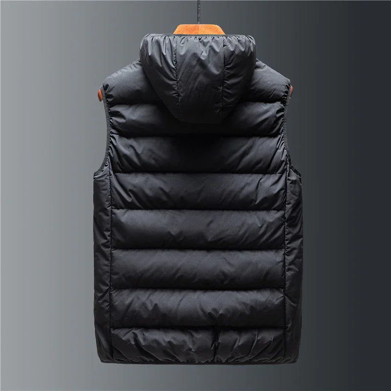 Black padded sleeveless puffer vest with hood hanging against gray background