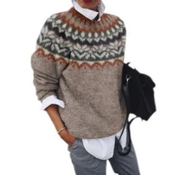 Person wearing cozy Nordic pattern wool sweater over white shirt with gray pants, carrying black bag