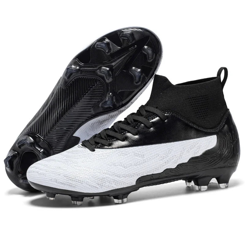 Black and white soccer cleats with high ankle sock design and studded sole for firm ground