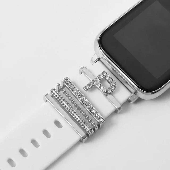 White smartwatch band decorated with silver and rhinestone charms, including a letter P charm