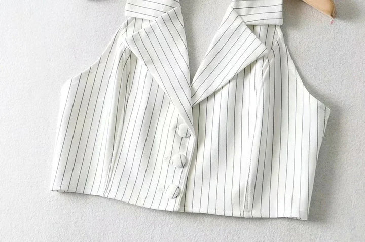 White sleeveless pinstripe cropped vest with wide collar and three fabric-covered buttons on hanger