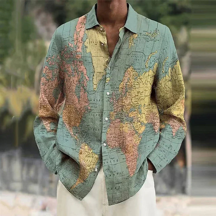 Man wearing long-sleeve button-up shirt with vintage world map print, hands in pockets
