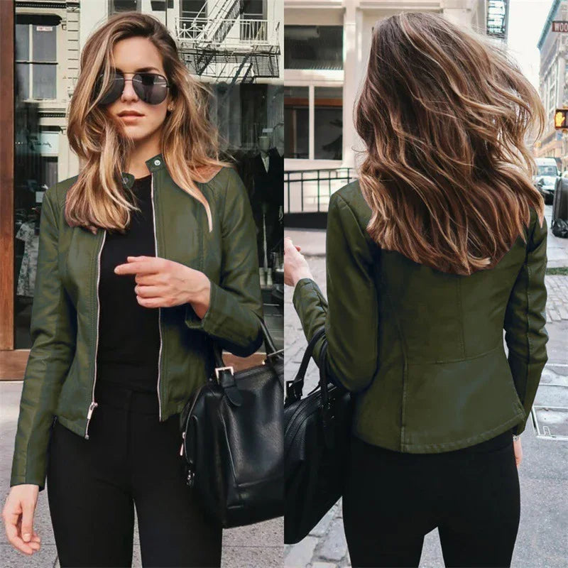 Woman wearing stylish olive green leather jacket and black pants, posing outdoors with sunglasses and black handbag