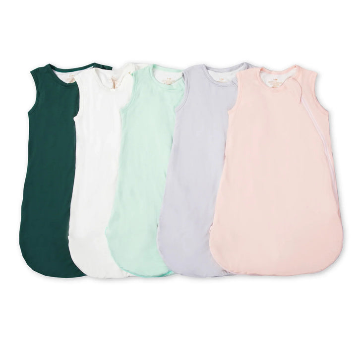 Five sleeveless baby sleeping bags in green, white, mint, lavender, and pink colors on white background