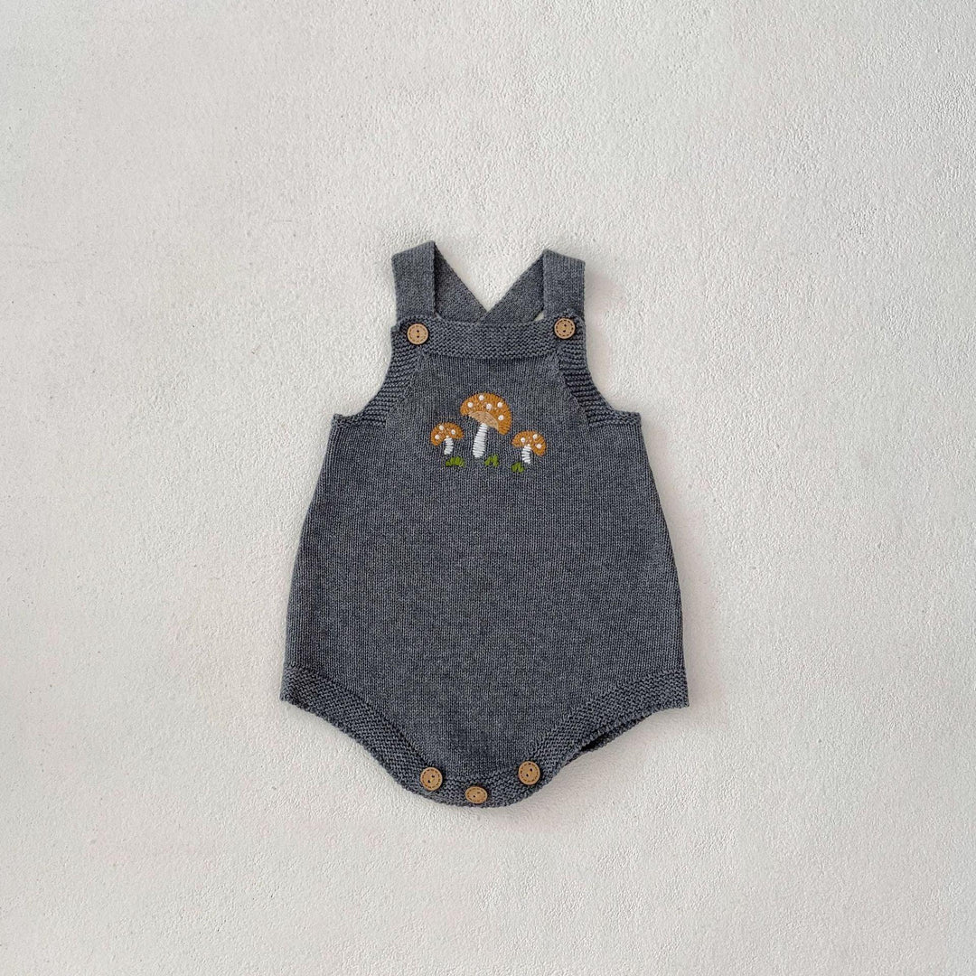 Gray knitted baby romper with embroidered orange mushrooms and wooden buttons on straps and bottom