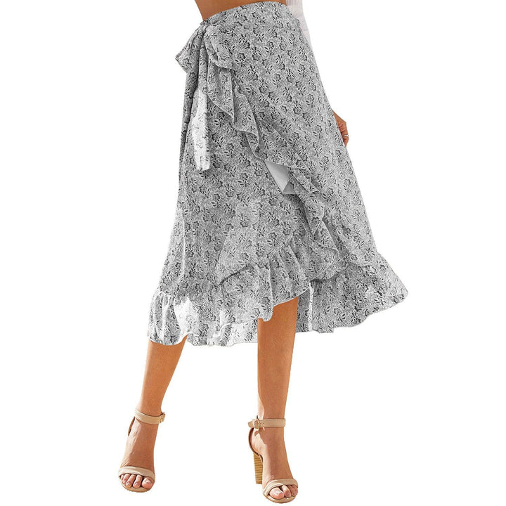 Woman wearing floral print wrap midi skirt with ruffles and beige ankle strap heels