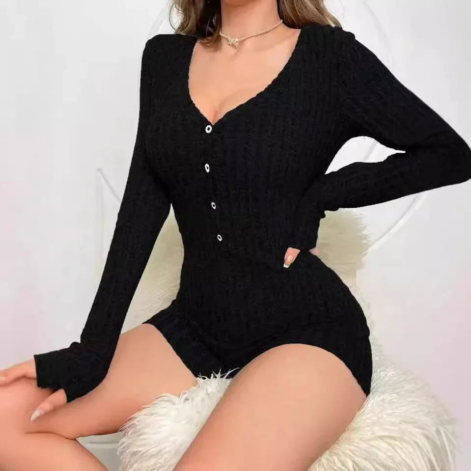 Woman wearing black long-sleeve buttoned knit romper seated on white fluffy chair