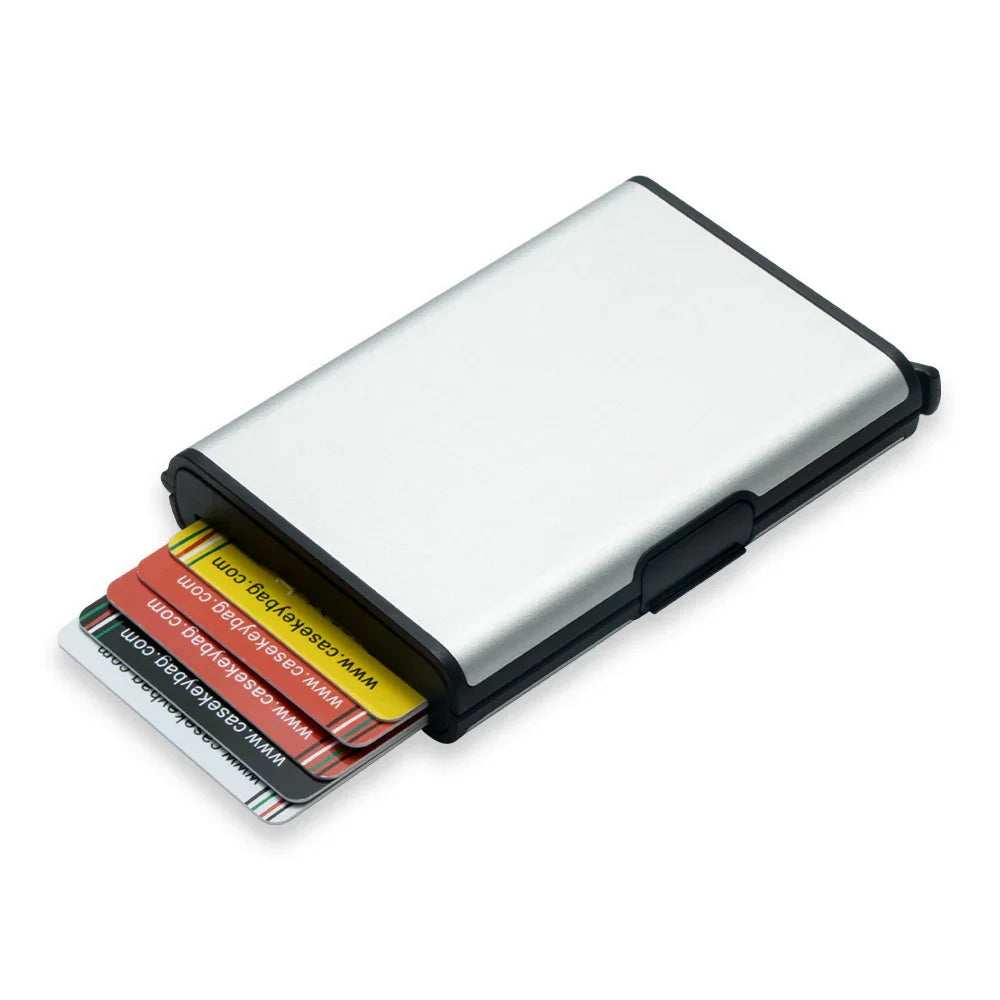 Silver metal card holder with black edges partially open showing colorful plastic cards inside