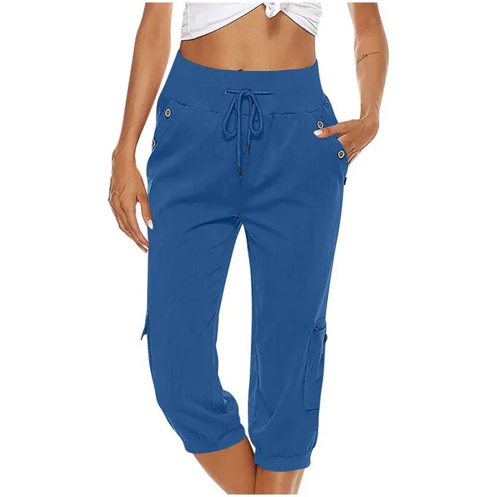 woman wearing blue capri cargo pants with drawstring waist and button details