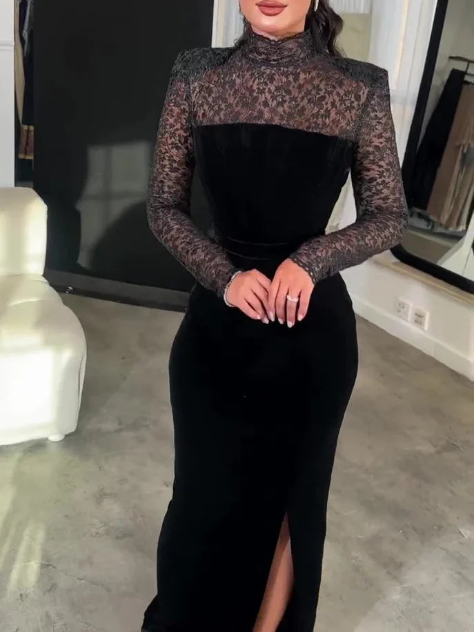 Woman in elegant black evening dress with lace long sleeves and high neckline posing indoors