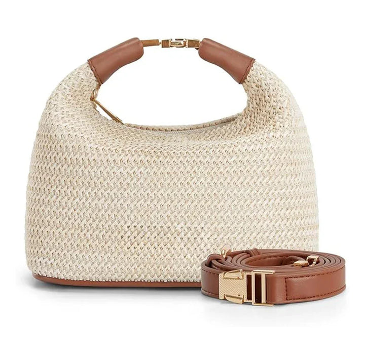 Beige woven straw handbag with brown leather handles and detachable strap on white background
