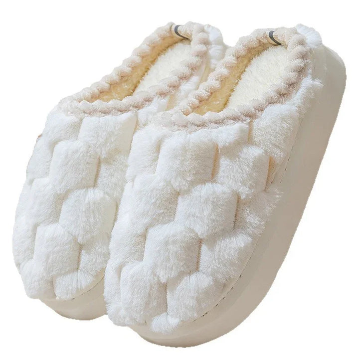Pair of white plush house slippers with soft quilted design and fuzzy interior lining