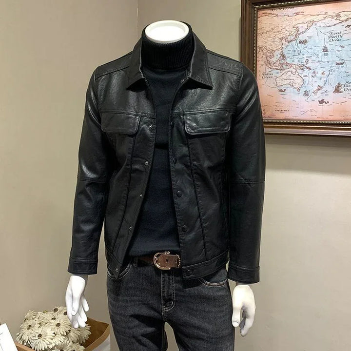 Men's black leather jacket on mannequin styled with black turtleneck and dark jeans indoors