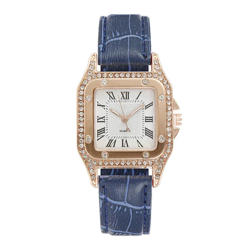 Elegant square gold watch with rhinestone bezel and blue leather strap with Roman numeral dial
