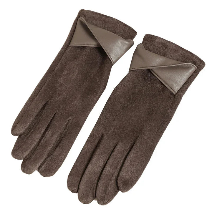Pair of brown suede gloves with leather trim detail on wrist against white background