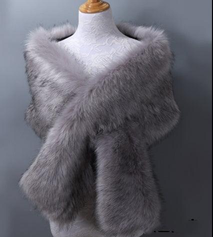 luxurious gray faux fur stole draped on white lace mannequin against gray background