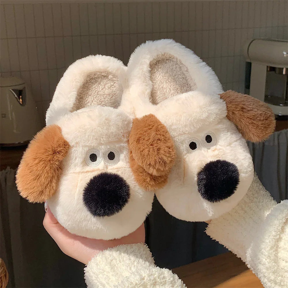 Soft cream-colored plush dog face slippers with brown ears and black noses held indoors