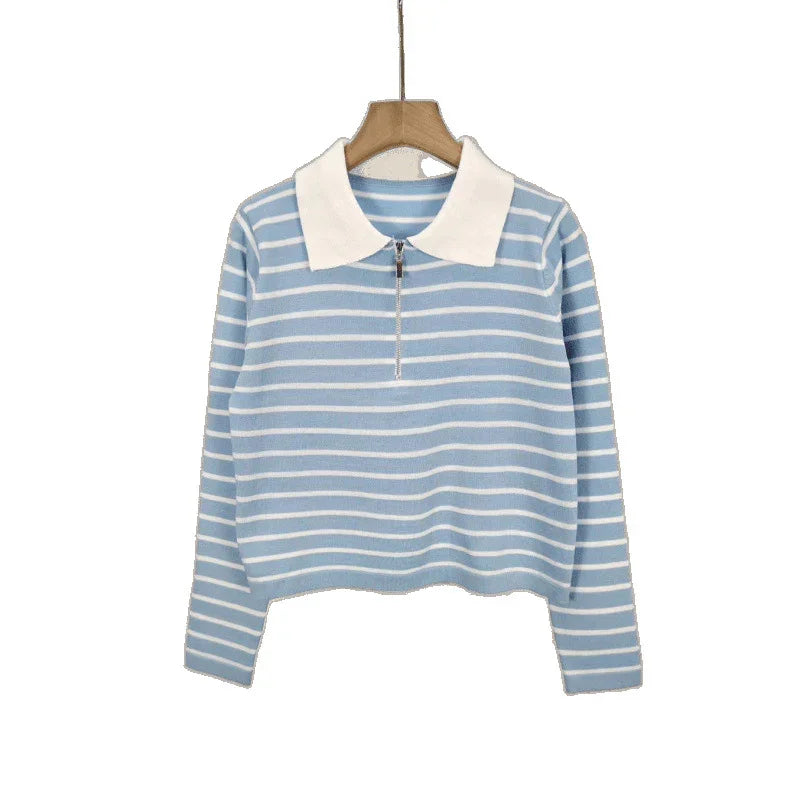 Light blue and white striped long sleeve shirt with white collar and zipper on wooden hanger