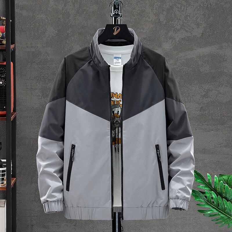Men's casual colorblock jacket in black and gray with zippered pockets on a hanger