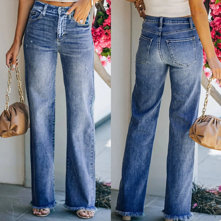 Front and back view of high-waisted blue straight-leg denim jeans with frayed hems worn with a white top and brown purse