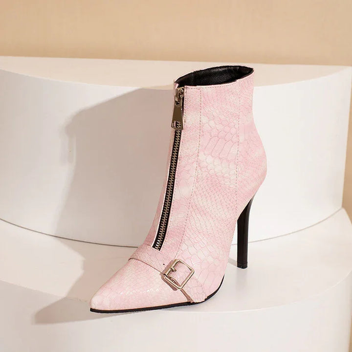 Pink high-heel ankle boot with front zipper, snakeskin texture, and buckle detail