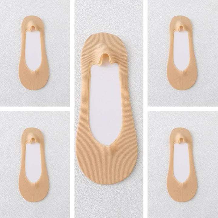 Beige no-show invisible socks with soft knit fabric displayed on textured white surface