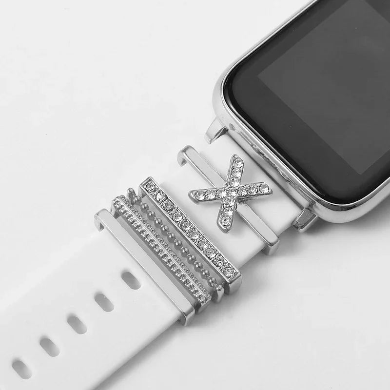 Smartwatch with white band featuring silver rhinestone charms and decorative accessories