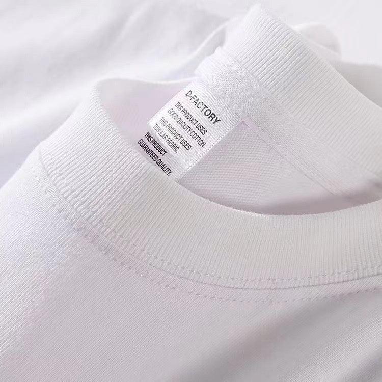 Close-up of white cotton t-shirt collar and tag showing D-Factory brand and fabric quality details
