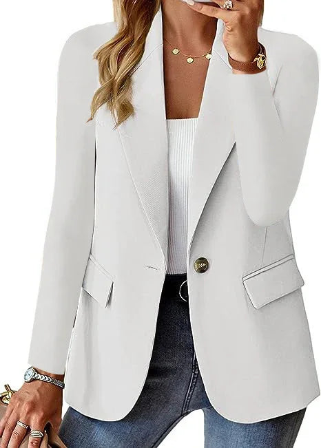 woman wearing stylish white single-button blazer with flap pockets over white ribbed top and jeans