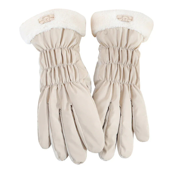 Pair of beige winter gloves with elastic wrist and white fleece cuffs featuring bear logo