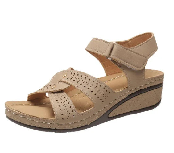 Beige women's wedge sandal with perforated straps and ankle Velcro closure