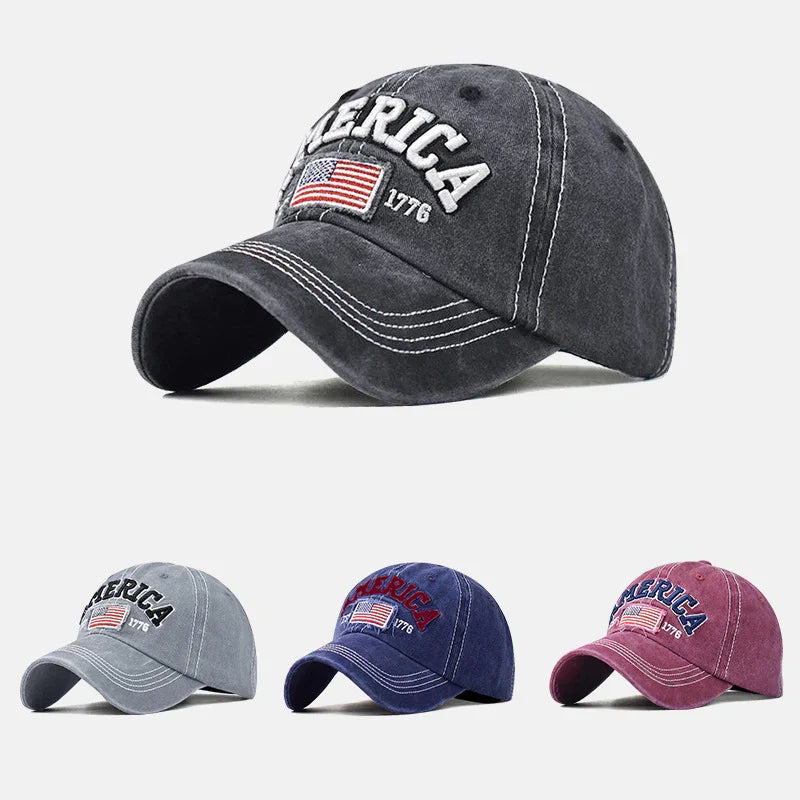 Vintage style baseball caps in black, gray, navy, and maroon with embroidered America, US flag, and 1776