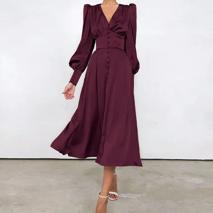 Woman wearing elegant long-sleeve burgundy midi dress with button details and white heels