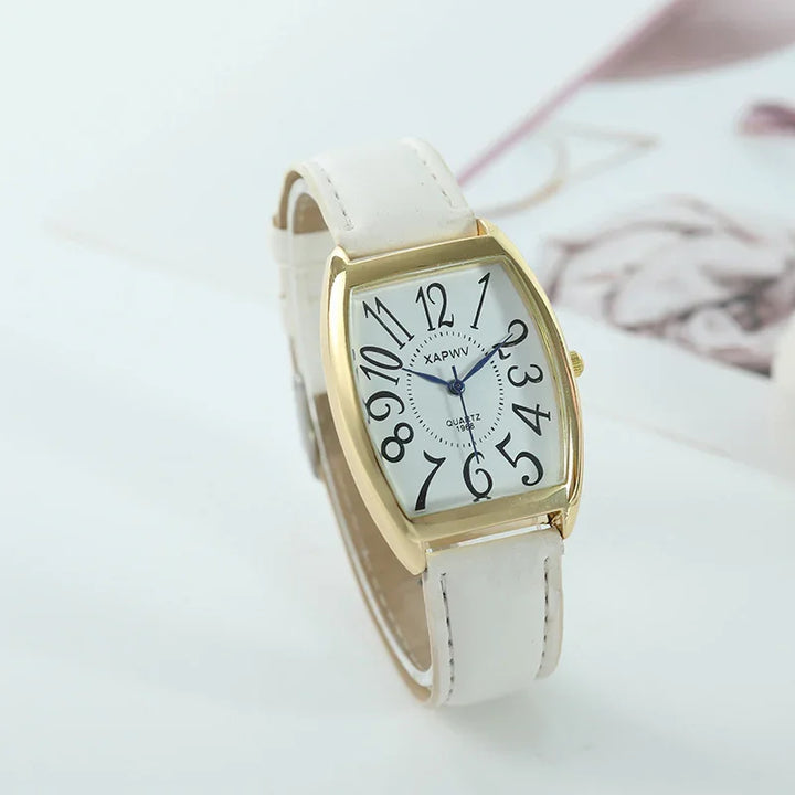 Stylish wristwatch with white leather band, gold-tone rectangular case, and distorted black numerals