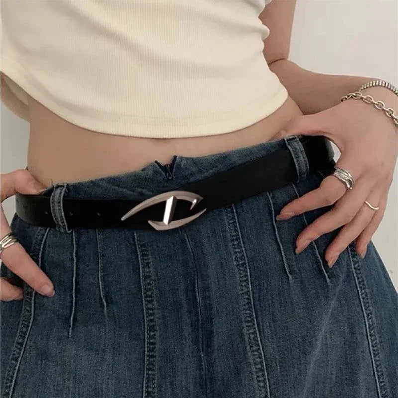 woman wearing black leather belt with silver buckle and high-waisted dark denim jeans