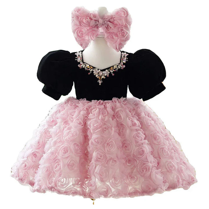Black puff sleeve baby dress with jeweled neckline and fluffy pink rose-patterned skirt and matching headband
