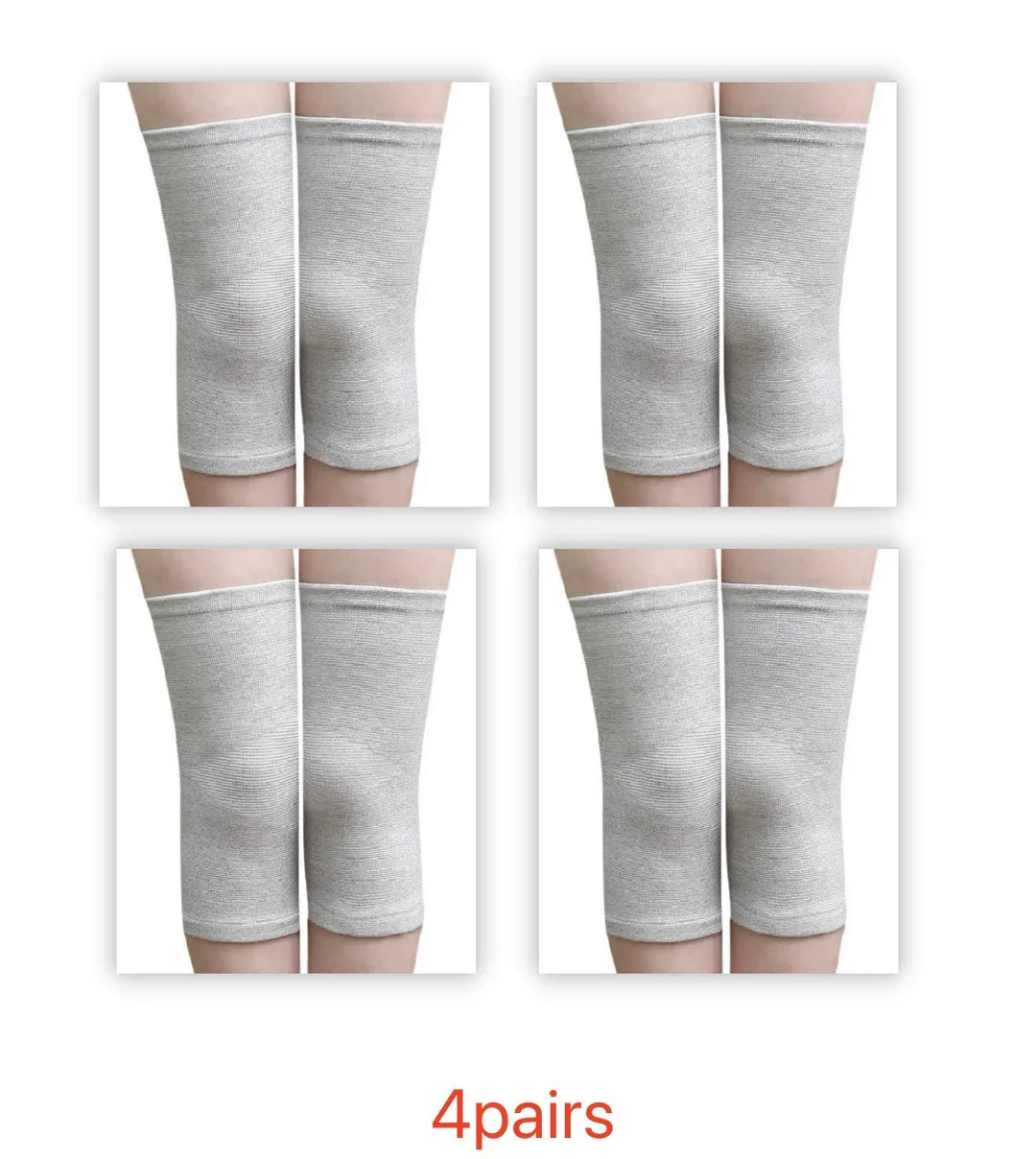 Four pairs of gray knee compression sleeves worn on legs, joint support socks