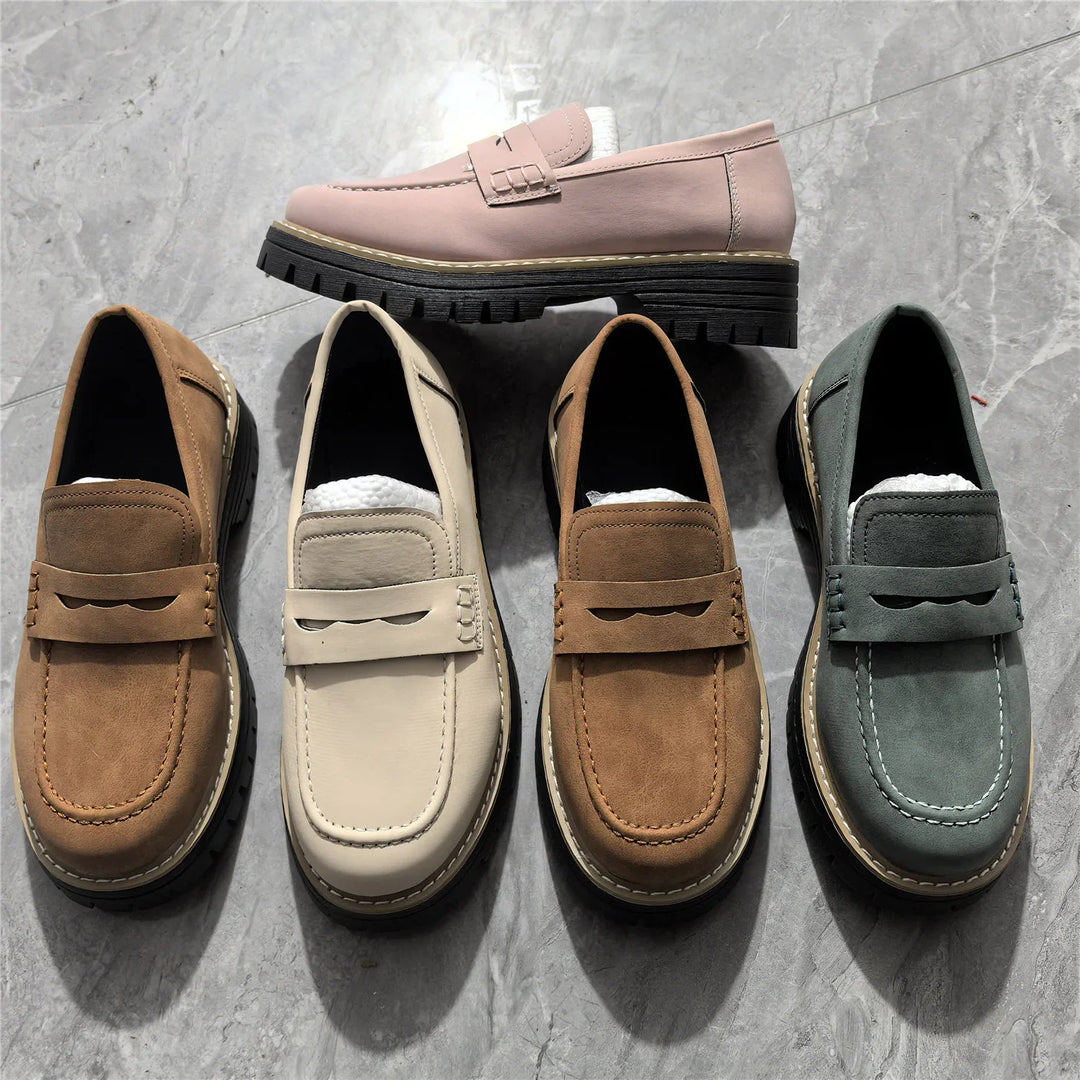 Collection of stylish leather loafers in pink, tan, beige, brown, and gray on gray marble floor