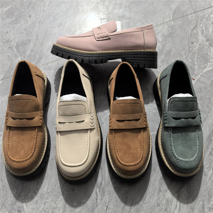 Collection of stylish leather loafers in pink, tan, beige, brown, and gray on gray marble floor