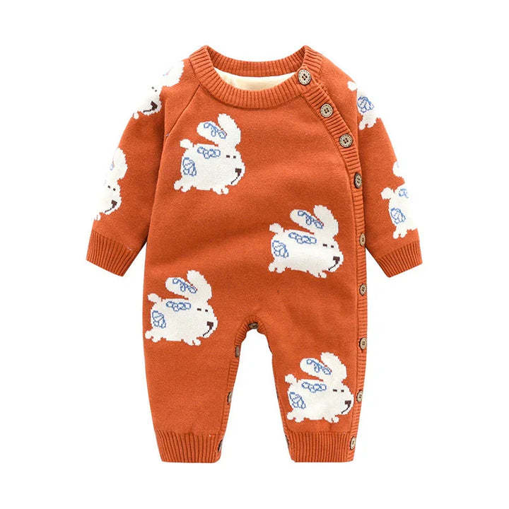 Orange baby onesie with white bunny patterns and side button closure on white background