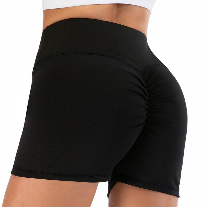 Close-up of black high-waisted ruched athletic shorts on a woman