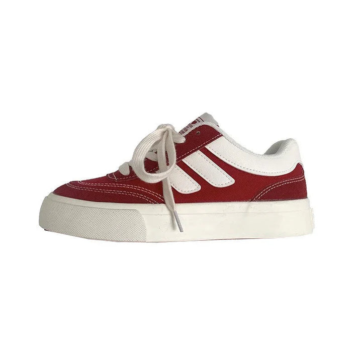 Red and white casual low-top sneaker with white laces and thick sole on white background