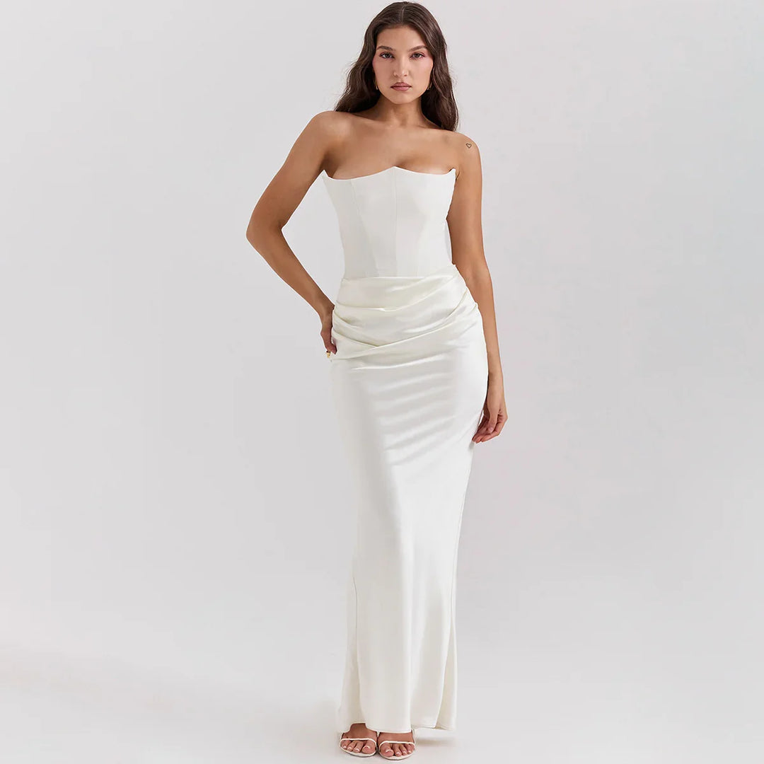 Woman in elegant strapless white satin evening gown with long skirt and ruched waist