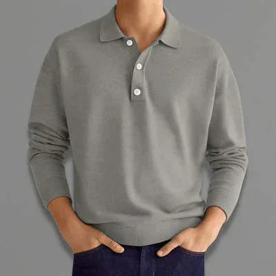 Man wearing grey long-sleeve polo shirt with buttoned collar and blue pants