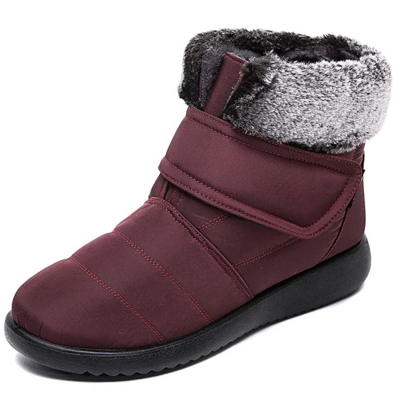 Maroon winter boot with black sole and gray faux fur cuff, padded and insulated design