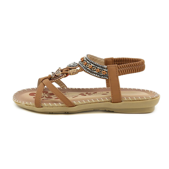Brown flat sandal with elastic ankle strap, decorative beads, and flower pattern insole