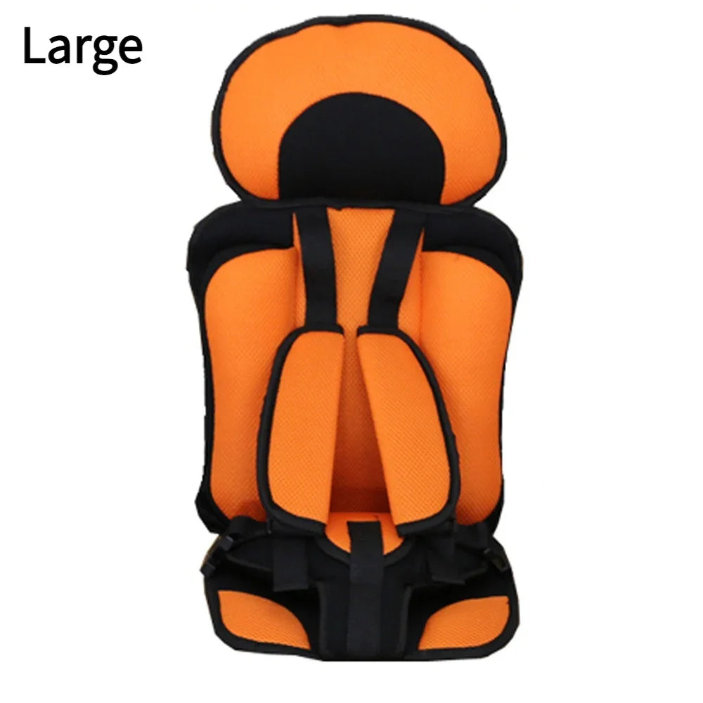 Large orange and black padded child safety car seat with harness straps
