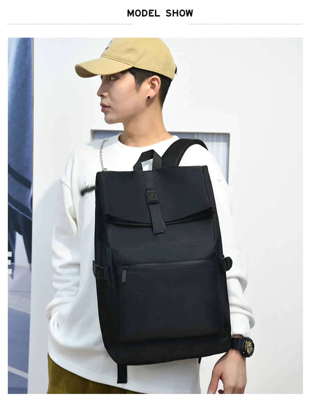 Young man wearing beige cap and white sweatshirt carrying large black backpack with front pocket