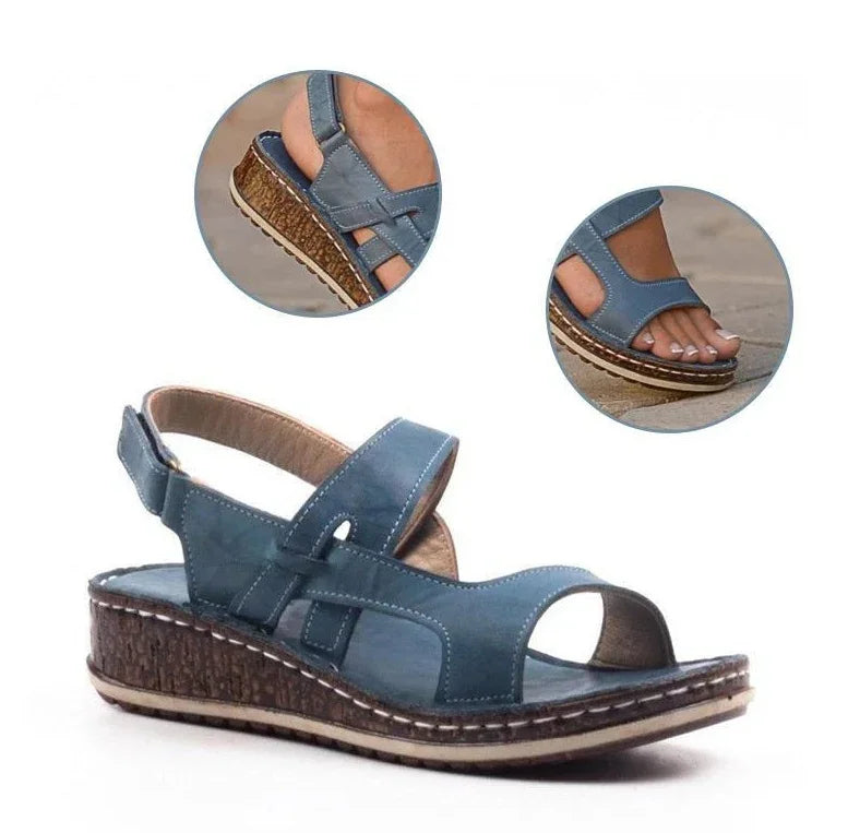 Blue leather women's wedge sandals with adjustable straps and cork-textured sole detail